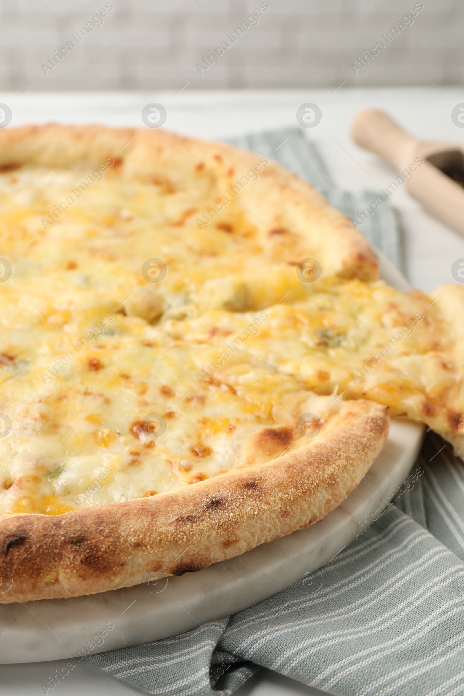 Photo of Delicious cut cheese pizza on table, closeup