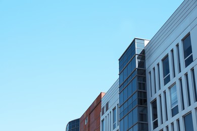 Photo of View of modern building against blue sky. Space for text