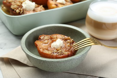 Tasty baked quinces with nuts and cream cheese served on table
