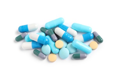 Photo of Heap of different colorful pills isolated on white, top view