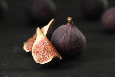 Tasty raw figs on black slate table, closeup