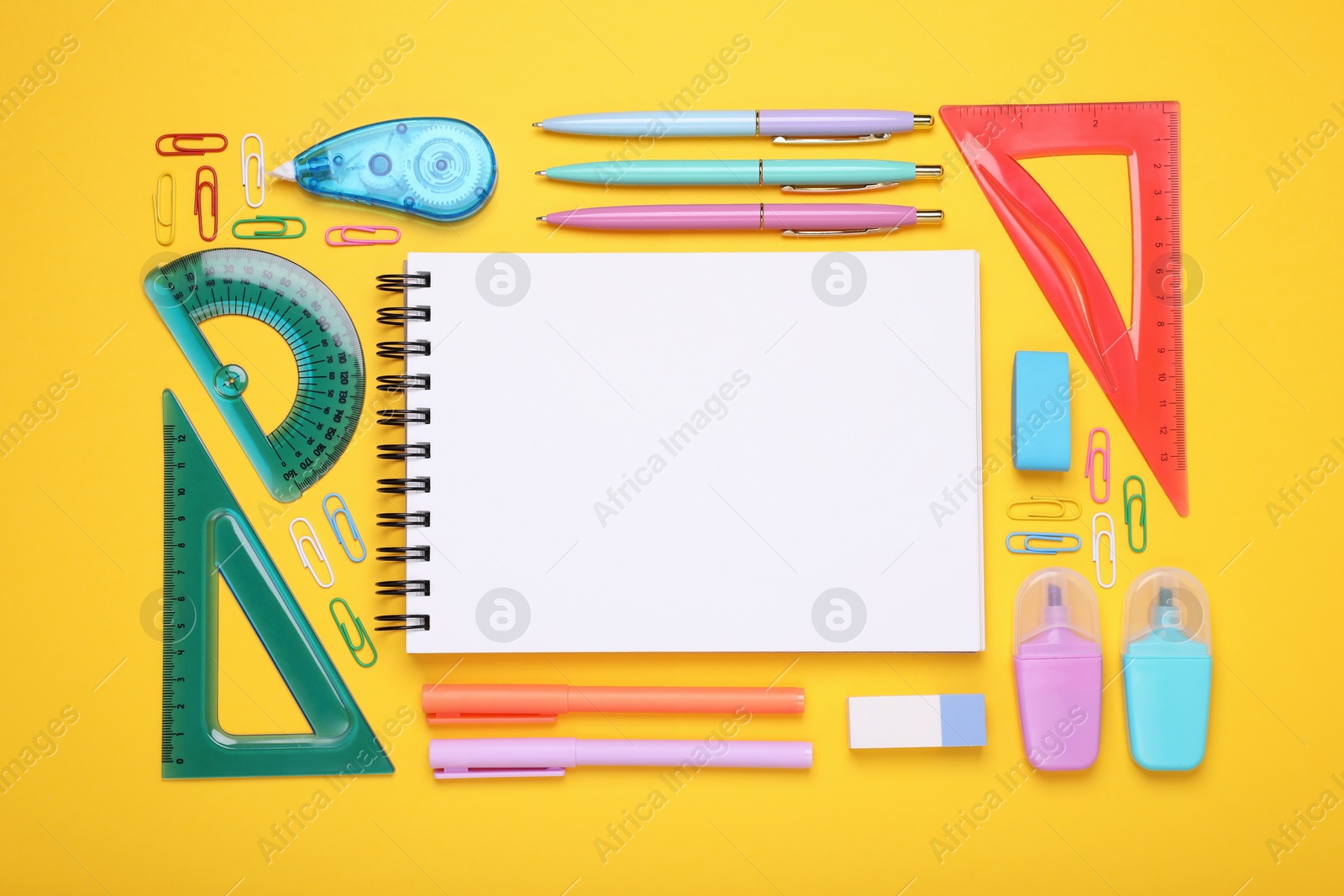 Photo of Flat lay composition with notebook and other school stationery on yellow background, space for text. Back to school