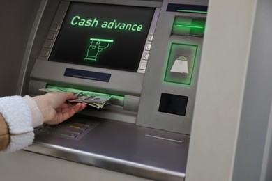 Image of Woman using cash machine for money withdrawal, closeup