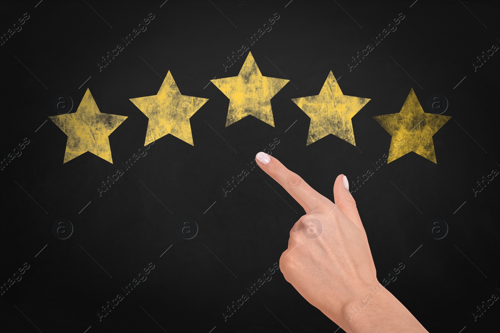 Image of Quality evaluation. Woman touching golden star on black chalkboard, closeup