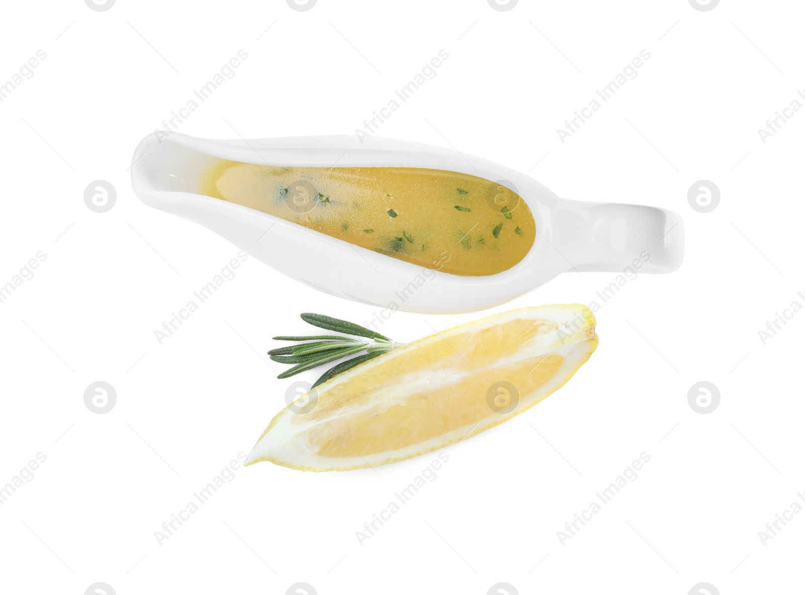 Photo of Ceramic sauce boat with lemon salad dressing and ingredients on white background, top view