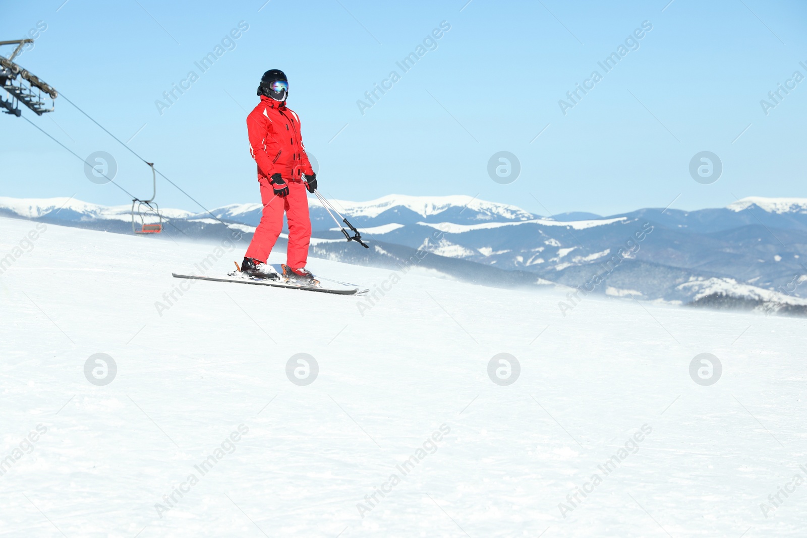 Photo of Male skier on snowy slope in mountains. Winter vacation