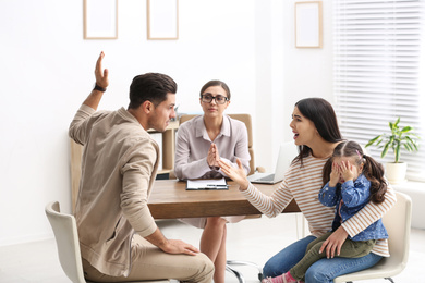 Photo of Professional psychologist working with family in office