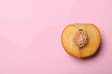 Half of sweet juicy peach on pink background, top view. Space for text