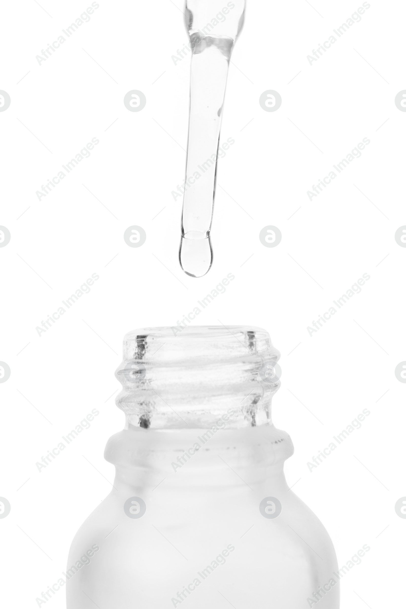 Photo of Dripping liquid from pipette into bottle isolated on white, closeup