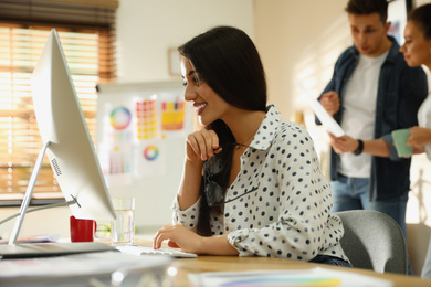 Photo of Female designer working with computer in office