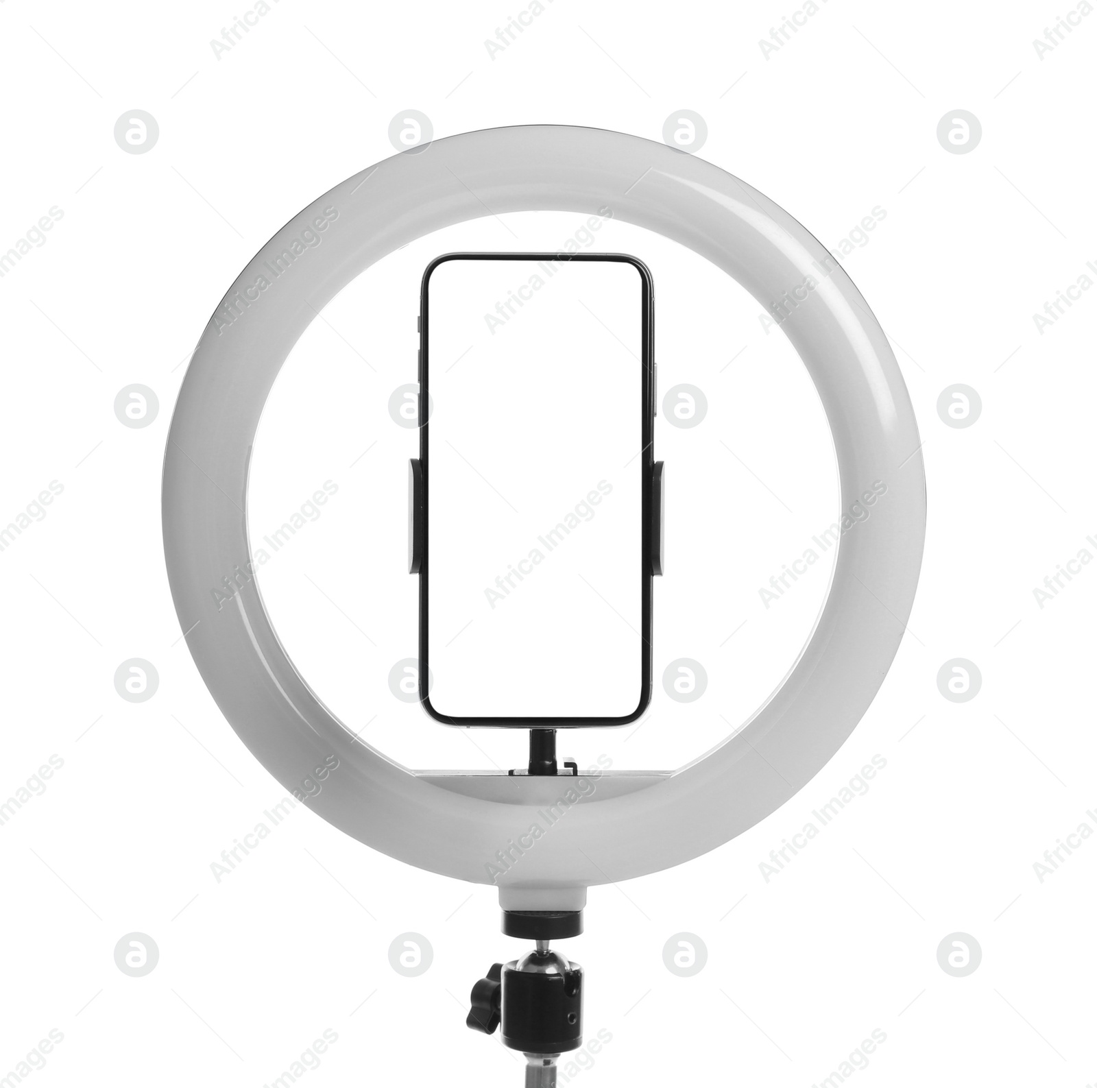 Photo of Modern tripod with ring light and smartphone isolated on white