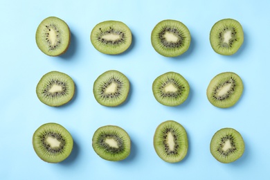 Top view of sliced kiwis on light blue background