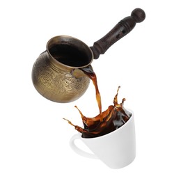 Pouring freshly brewed aromatic coffee from turkish pot into cup. Objects in air on white background