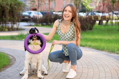 Photo of Woman playing with her English Springer Spaniel dog outdoors