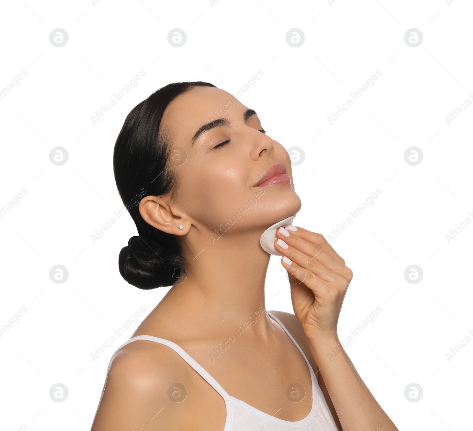 Photo of Young woman using cotton pad with micellar water on white background