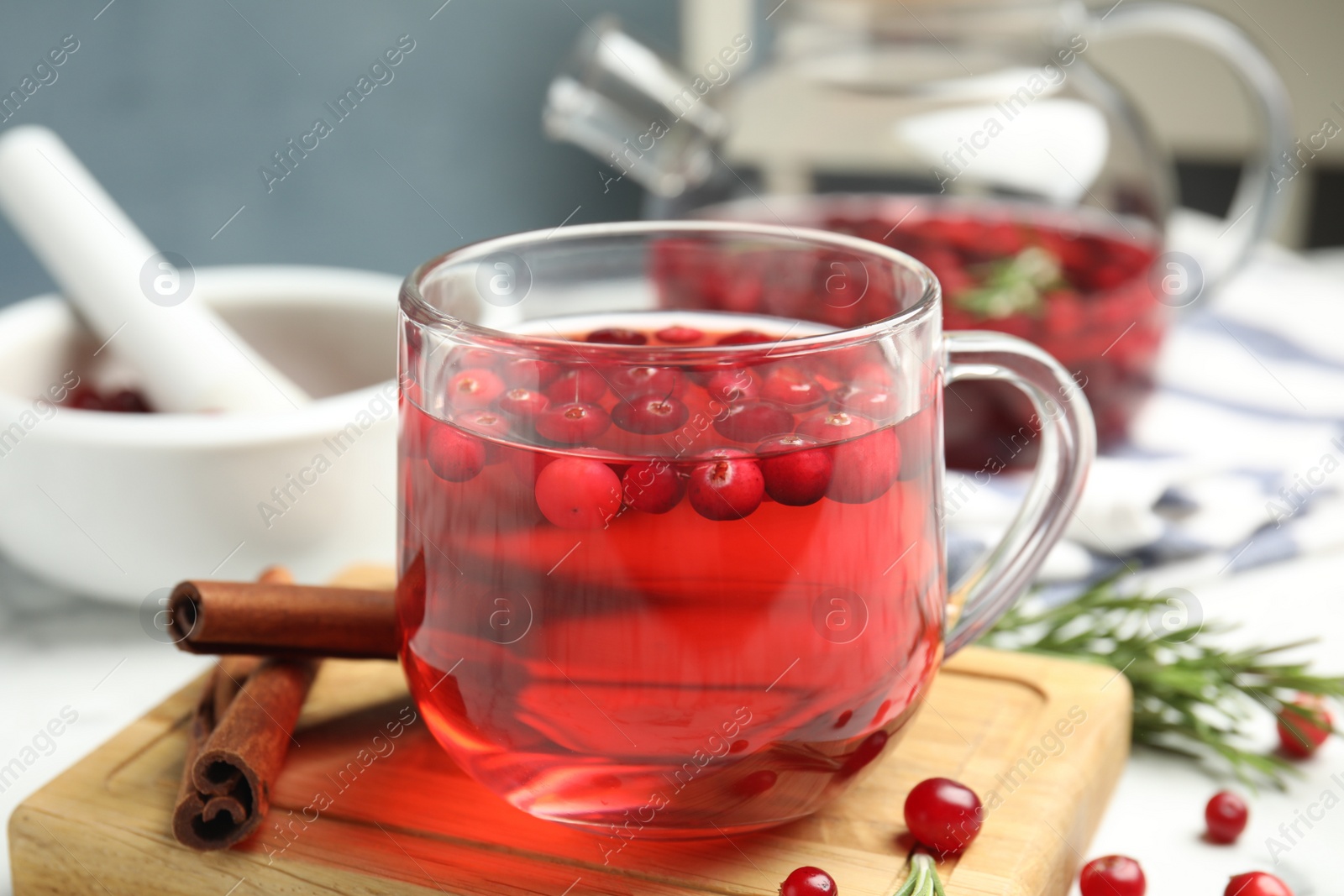 Photo of Tasty hot cranberry tea and fresh ingredients on table