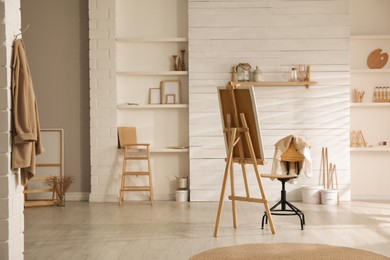 Modern studio interior with artist's workplace and decorative elements