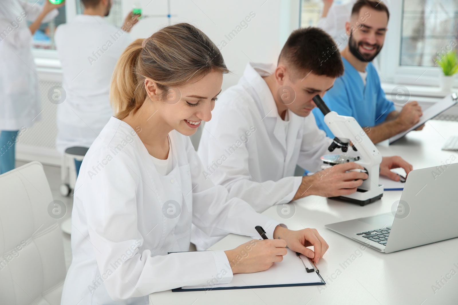 Photo of Medical students working in modern scientific laboratory