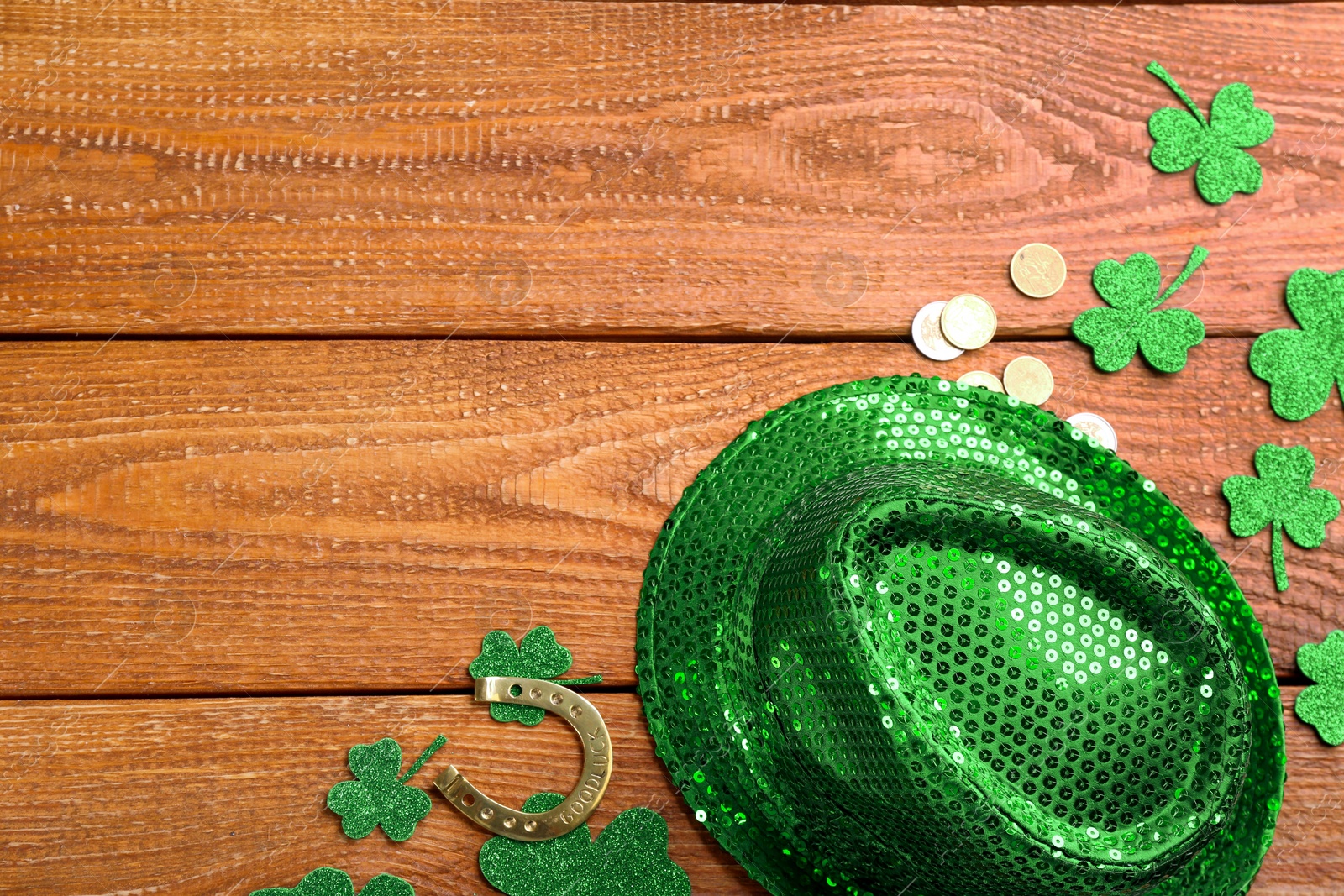 Photo of Leprechaun's hat and St. Patrick's day decor on wooden background, flat lay. Space for text