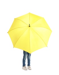 Photo of Little boy hiding behind yellow umbrella on white background