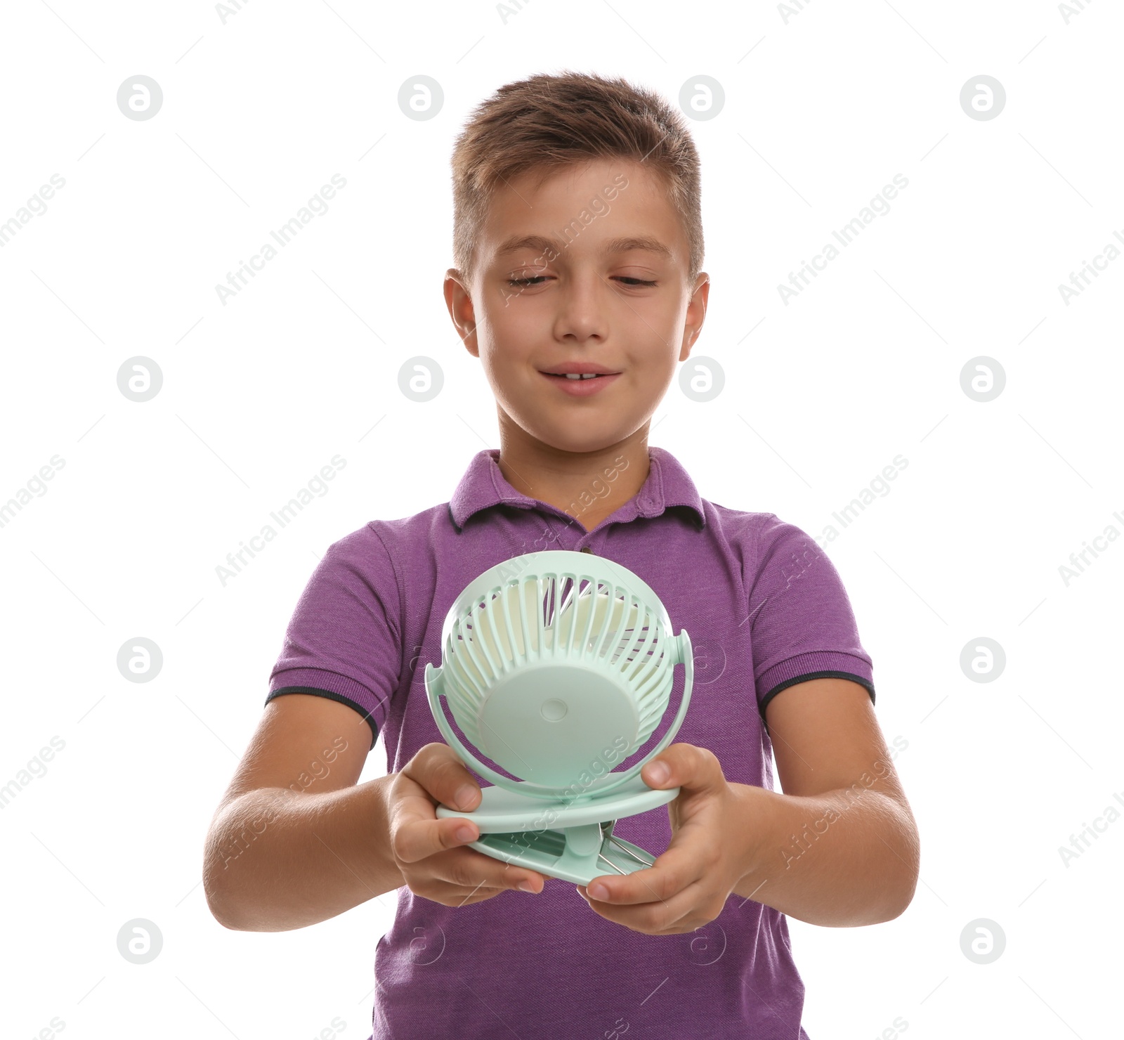 Photo of Little boy enjoying air flow from portable fan on white background. Summer heat