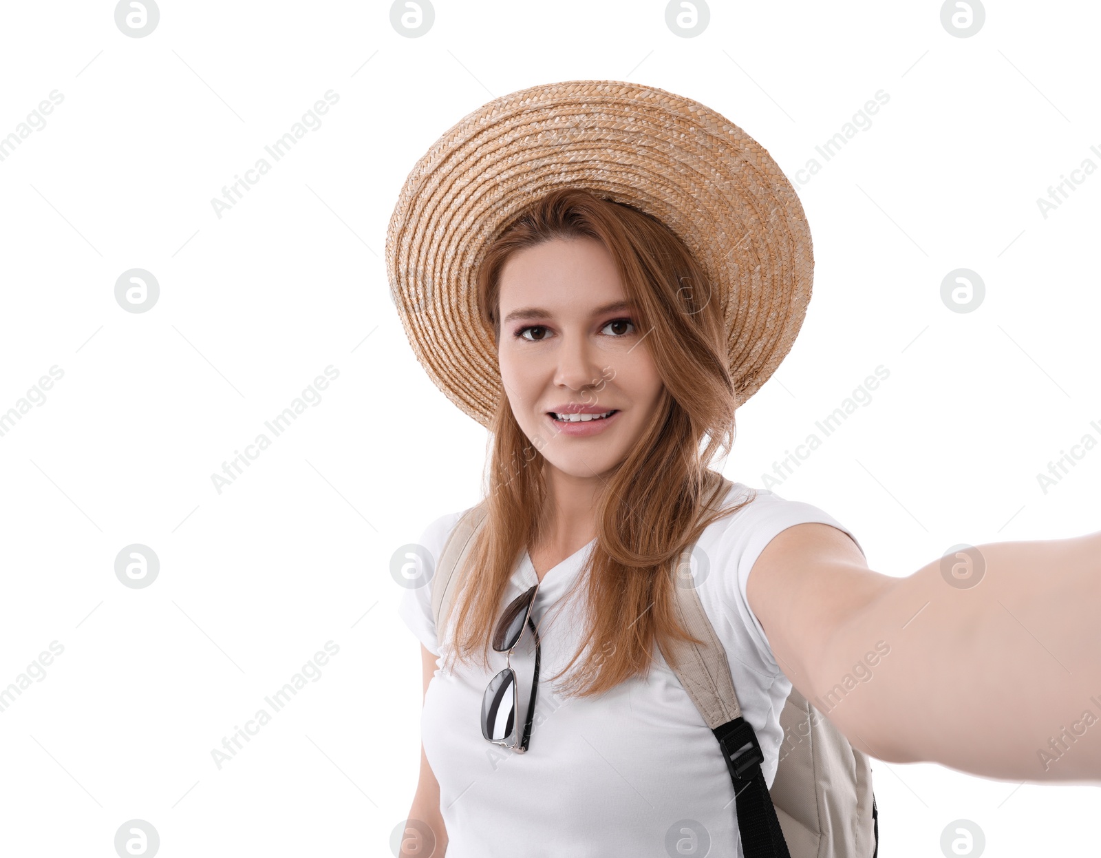 Photo of Beautiful woman in straw hat taking selfie on white background