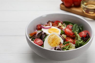 Photo of Delicious salad with boiled egg, bacon and vegetables on white wooden table, closeup