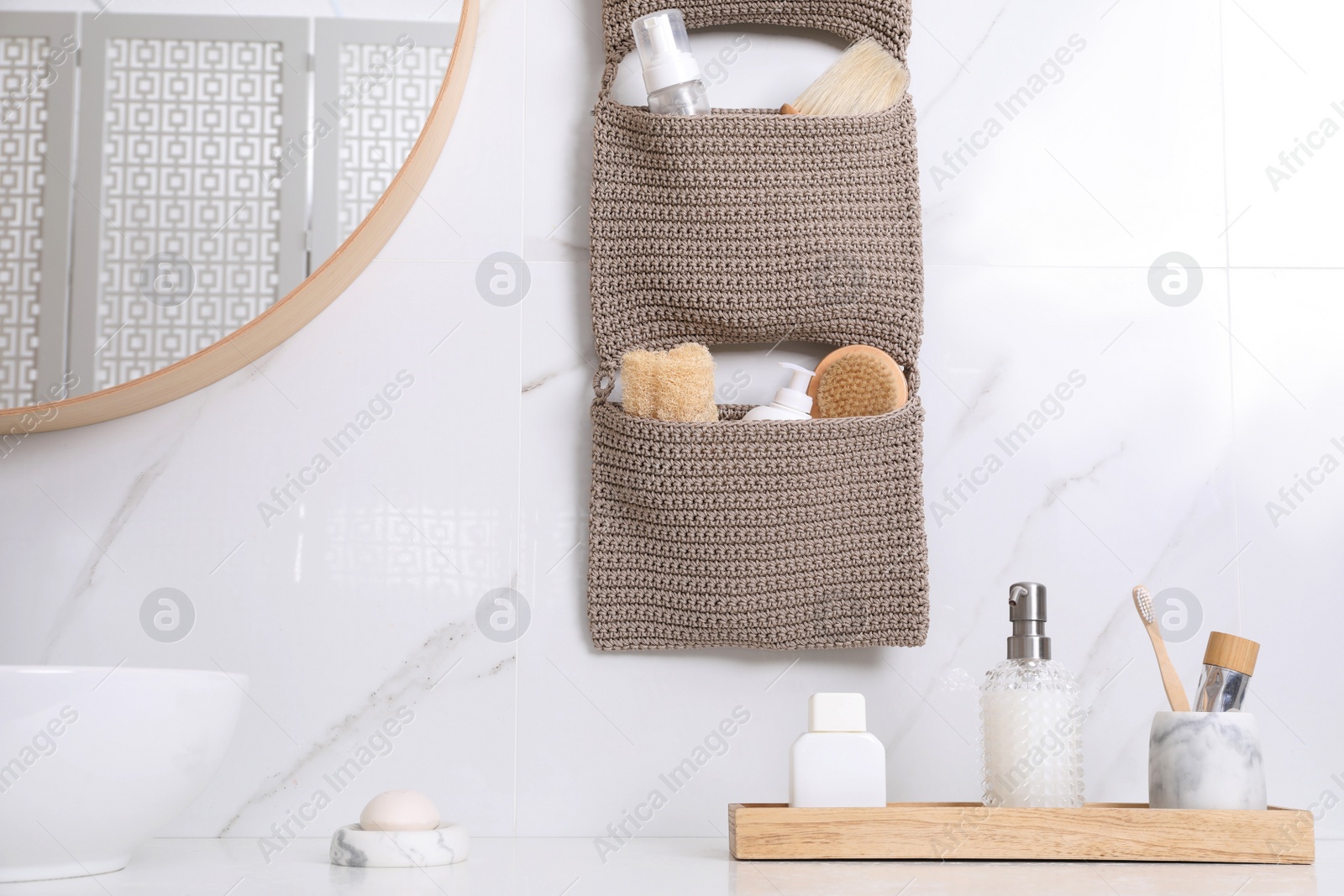 Photo of Countertop and storage with essentials in bathroom. Stylish accessory