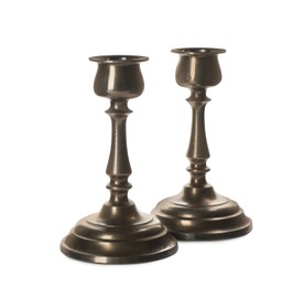 Photo of Two vintage metal candlesticks on white background