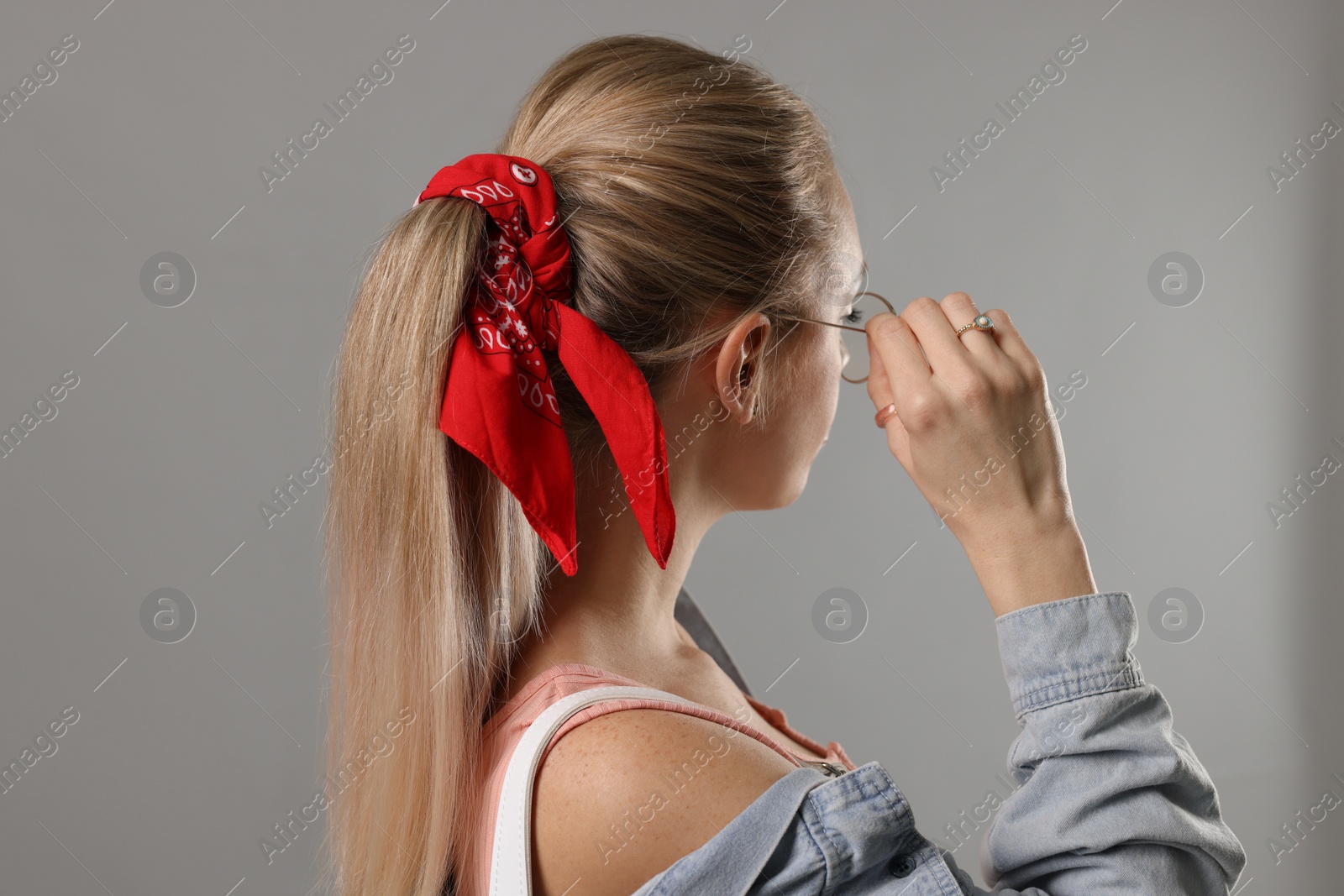 Photo of Woman with stylish red bandana on light grey background