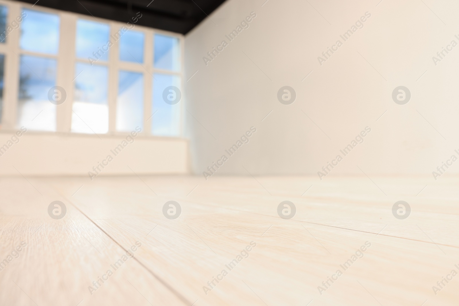 Photo of Empty room with new white laminated flooring, closeup