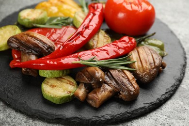 Delicious grilled vegetables on grey table, closeup