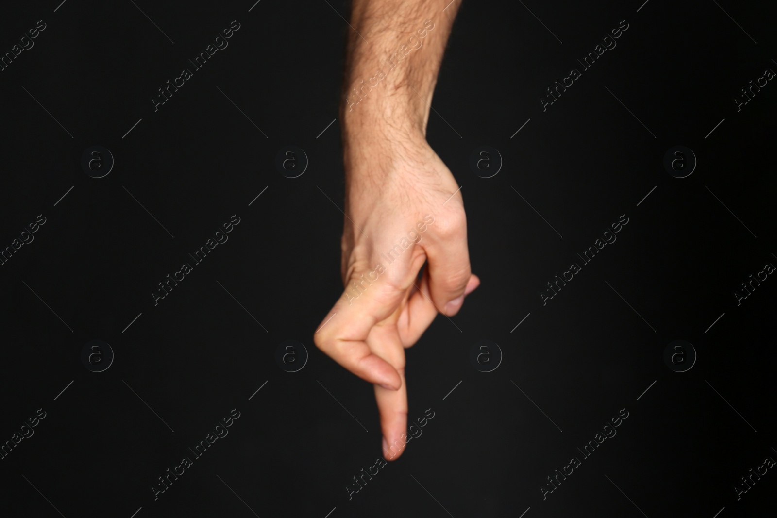 Photo of Man imitating walk with hand on black background, closeup. Finger gesture