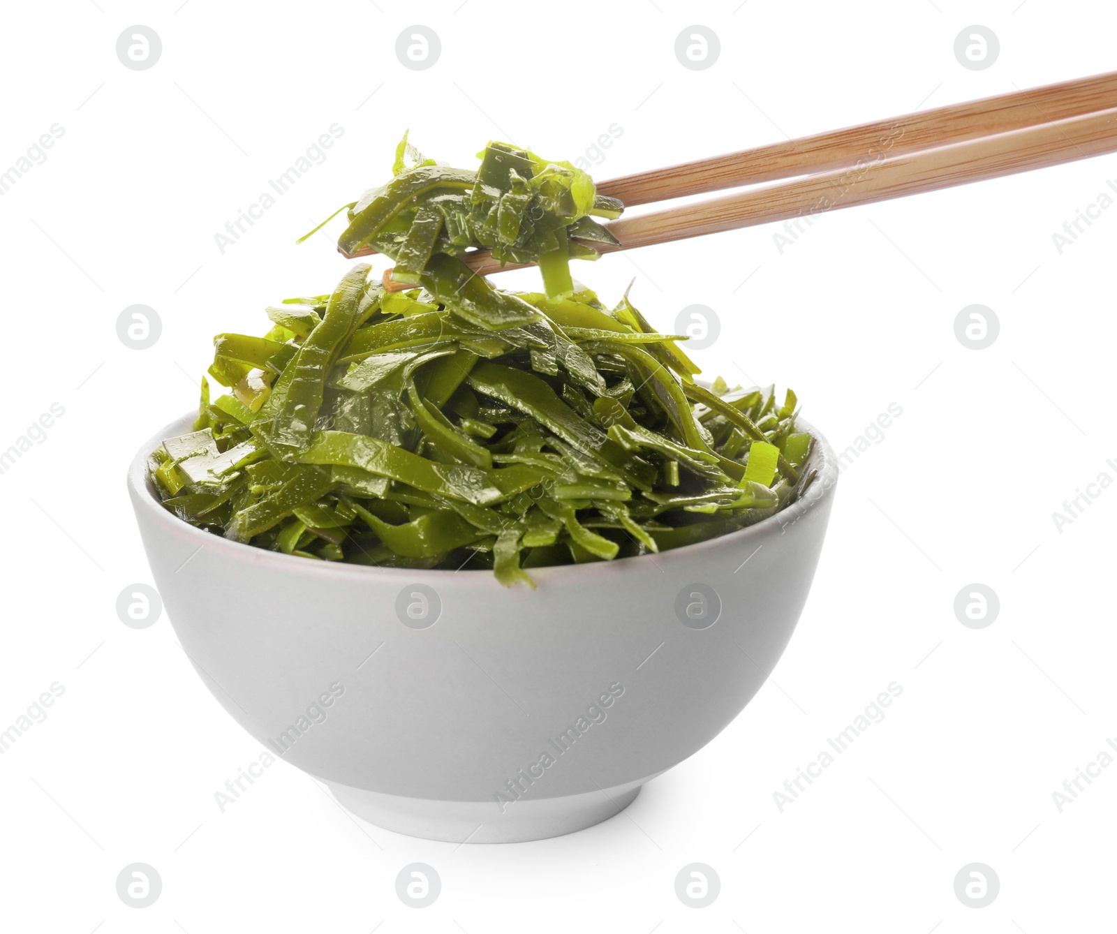 Photo of Fresh laminaria (kelp) seaweed in bowl and chopsticks on white background