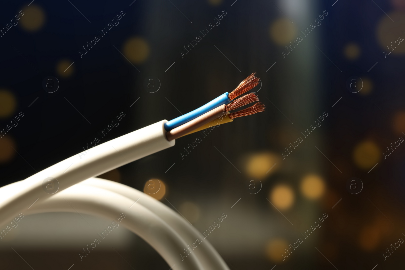 Photo of Cable with copper wires against blurred background, closeup