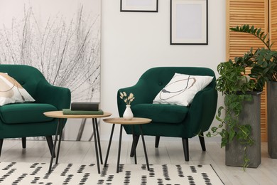 Photo of Comfortable armchairs and nesting tables in stylish room