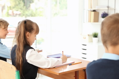 Little children in classroom. Stylish school uniform