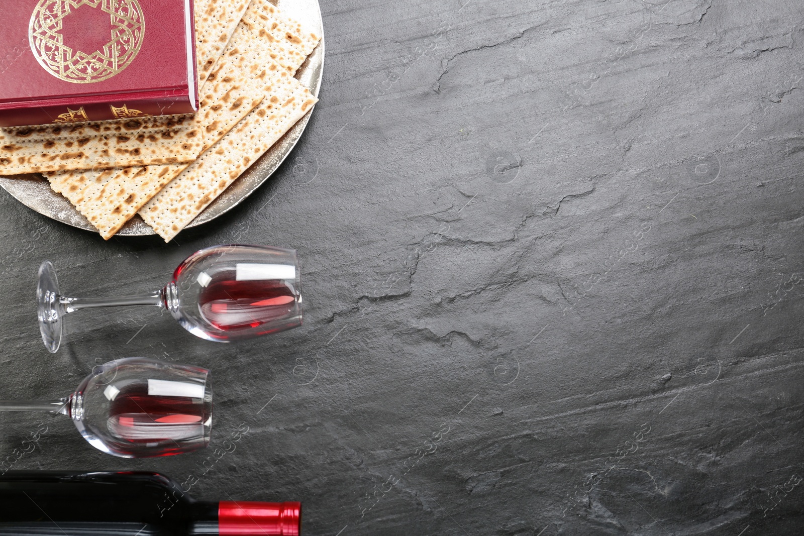 Photo of Flat lay composition with traditional Pesach (Passover Seder) items on grey table. Space for text