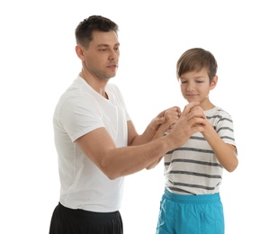 Photo of Dad teaching his son to fight isolated on white