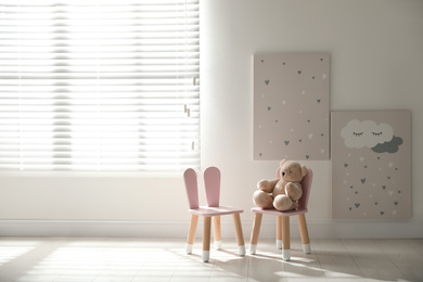 Cute chairs with bunny ears in children's room interior