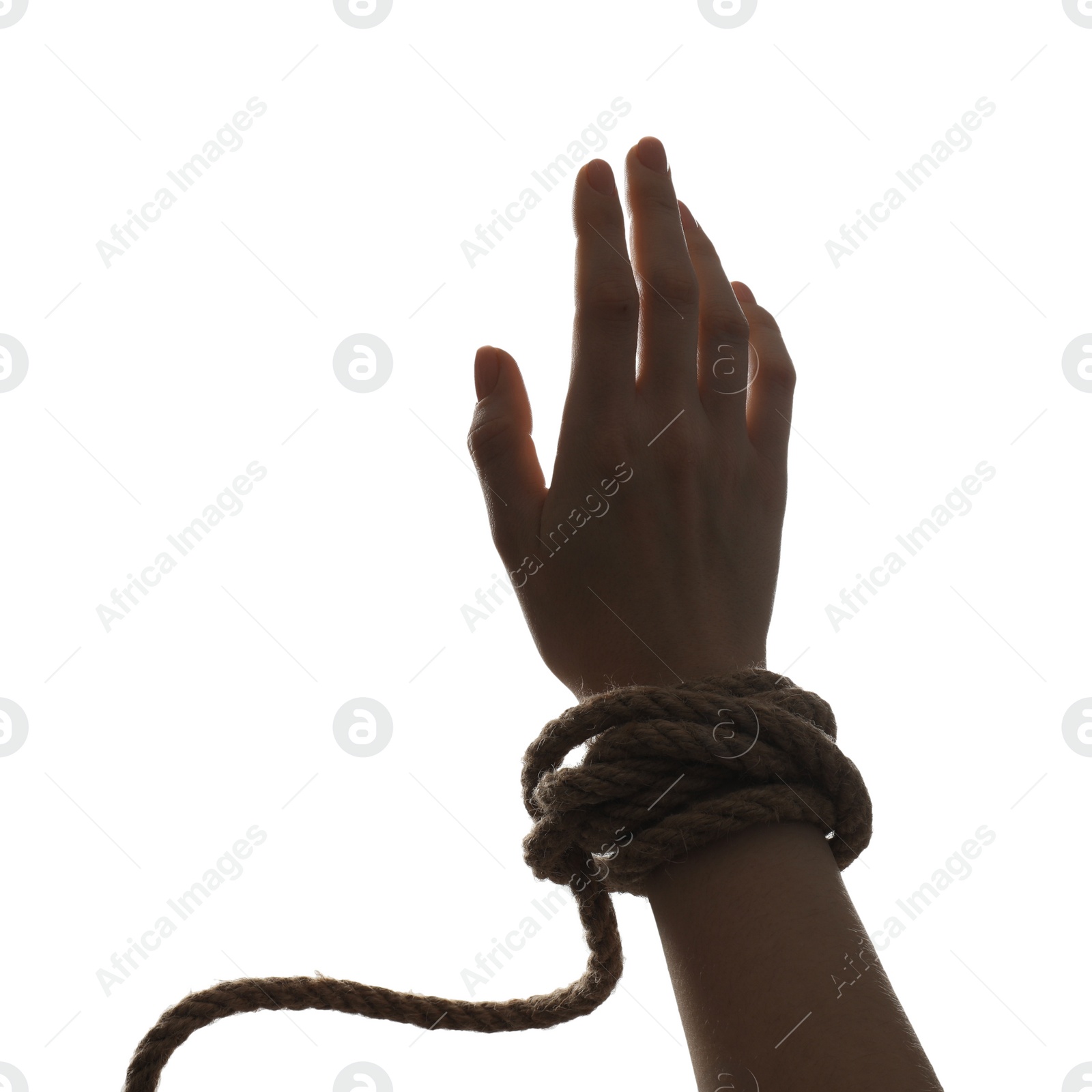 Photo of Freedom concept. Woman with rope on her hand against white background, closeup