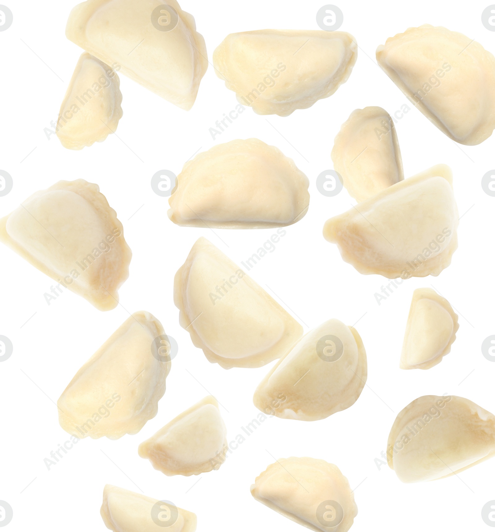 Image of Many tasty dumplings falling on white background