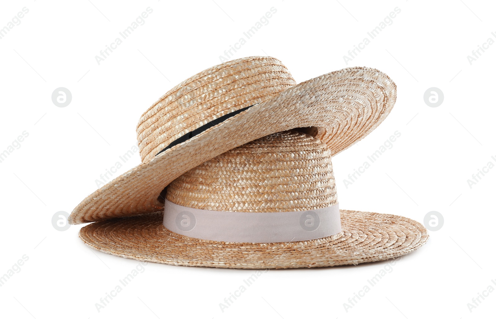 Photo of Straw hats isolated on white. Stylish accessory