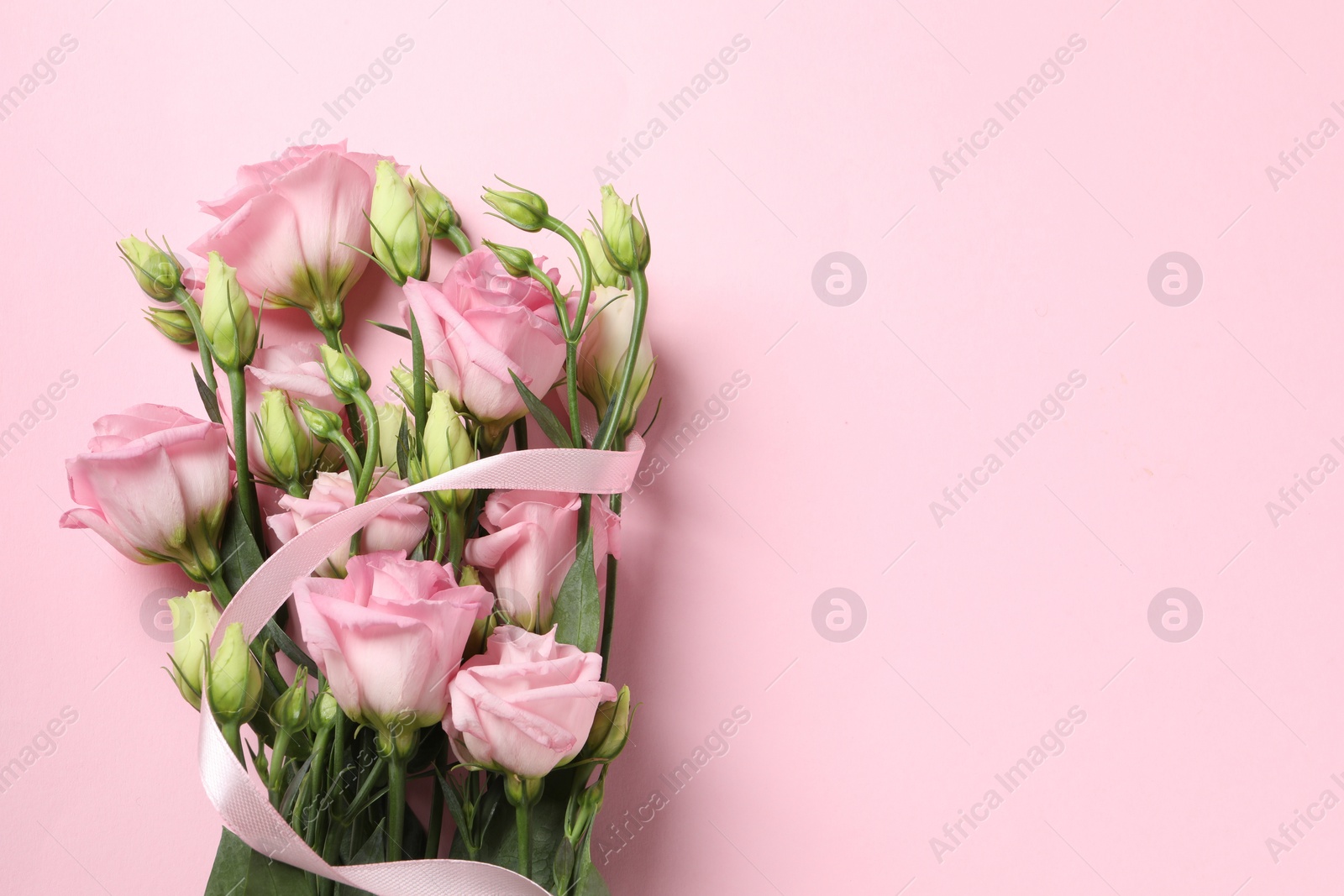 Photo of Happy Mother's Day. Beautiful flowers and ribbon on pink background, top view. Space for text