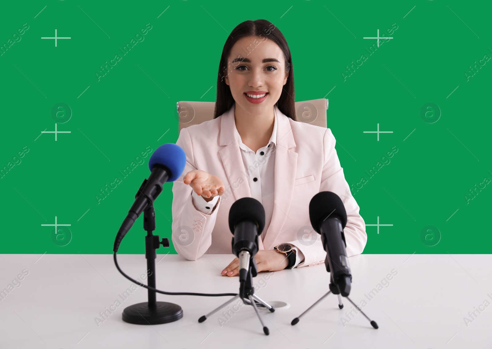 Image of Chroma key compositing. Woman giving interview during news conference. Green screen behind her