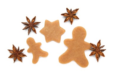 Photo of Unbaked Christmas cookies and anise on white background, top view