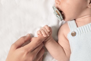 Photo of Mother and her newborn baby on bed, top view