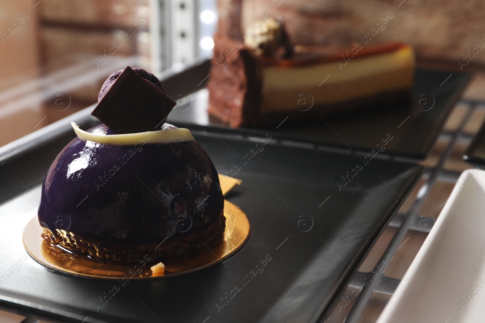 Photo of Delicious dessert decorated with macaron on plate, closeup. Space for text