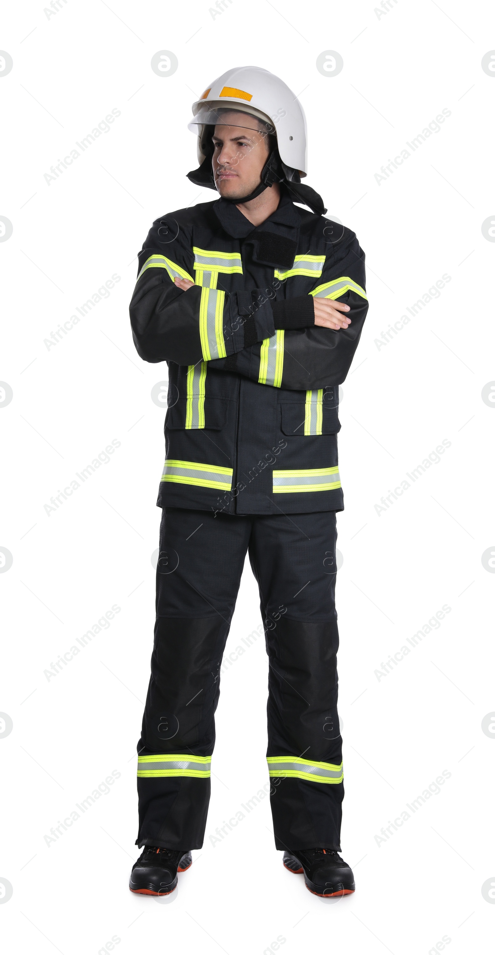 Photo of Full length portrait of firefighter in uniform and helmet on white background