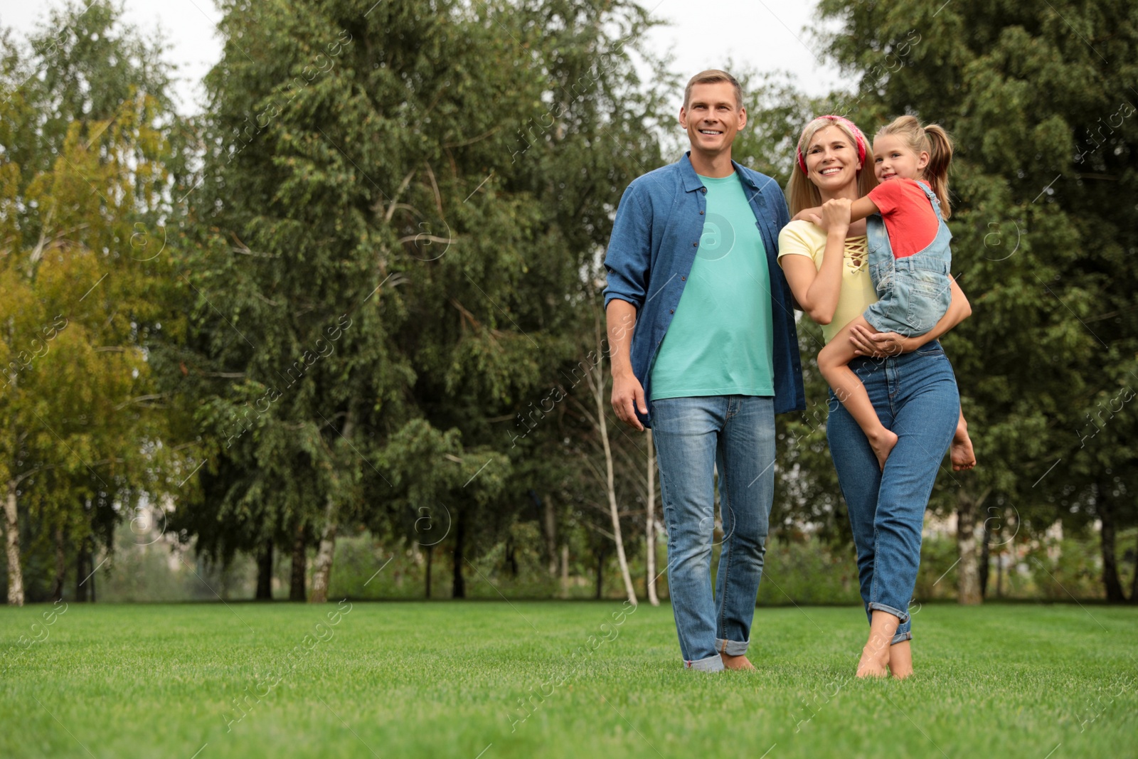 Photo of Happy family spending time together in park on sunny summer day